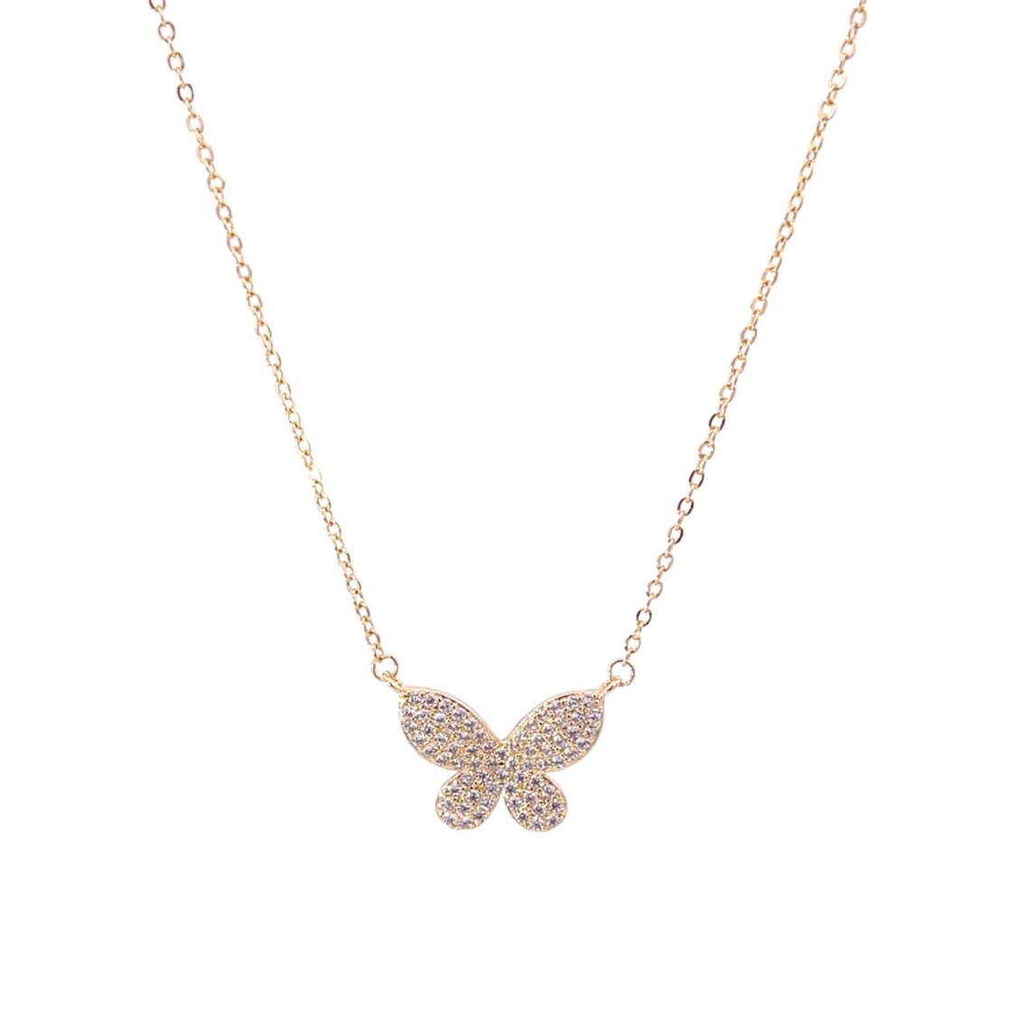 A delicate gold butterfly pendant necklace sparkles with pavé crystals on a fine chain against a white background.