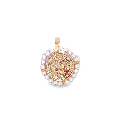 A gold Saint Benedict medal pendant framed by a circle of delicate white pearls rests against a plain white background.
