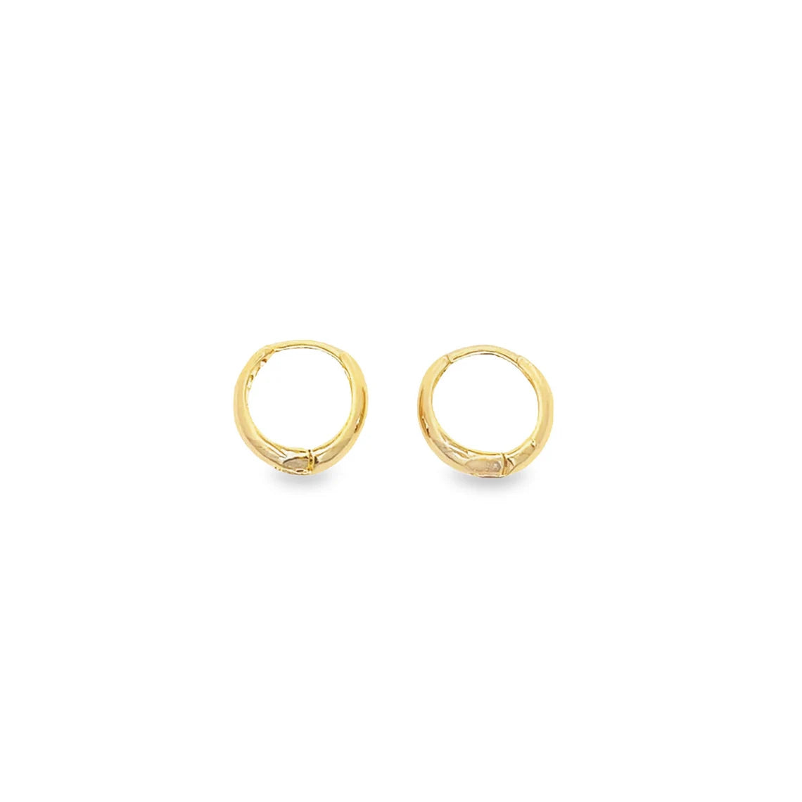 A pair of polished gold huggie hoop earrings rests against a clean white background.