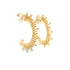 A pair of gold sunburst hoop earrings resting against a clean white background.
