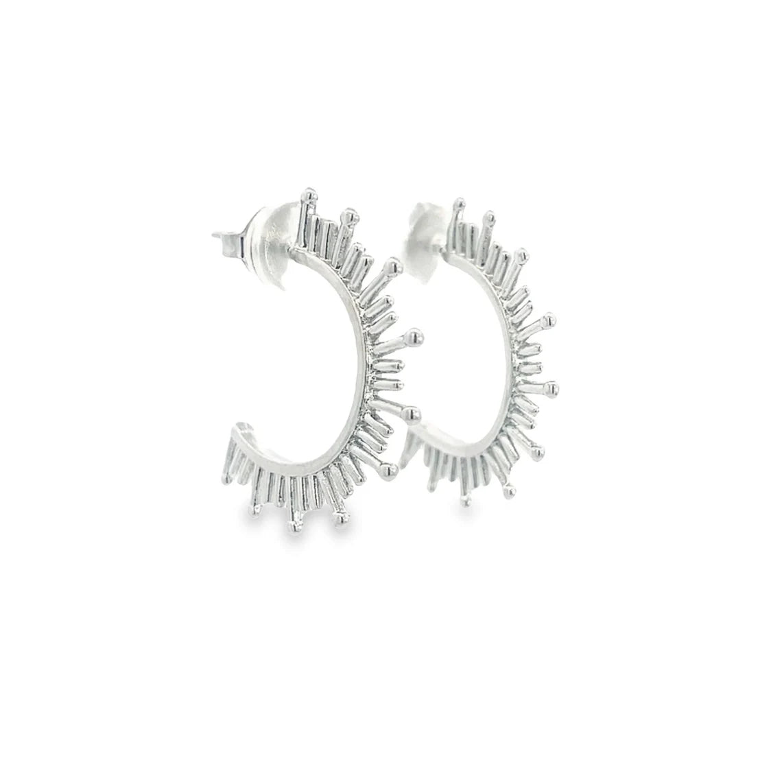 A pair of silver sunburst hoop earrings feature intricate radiating spikes against a clean white background.
