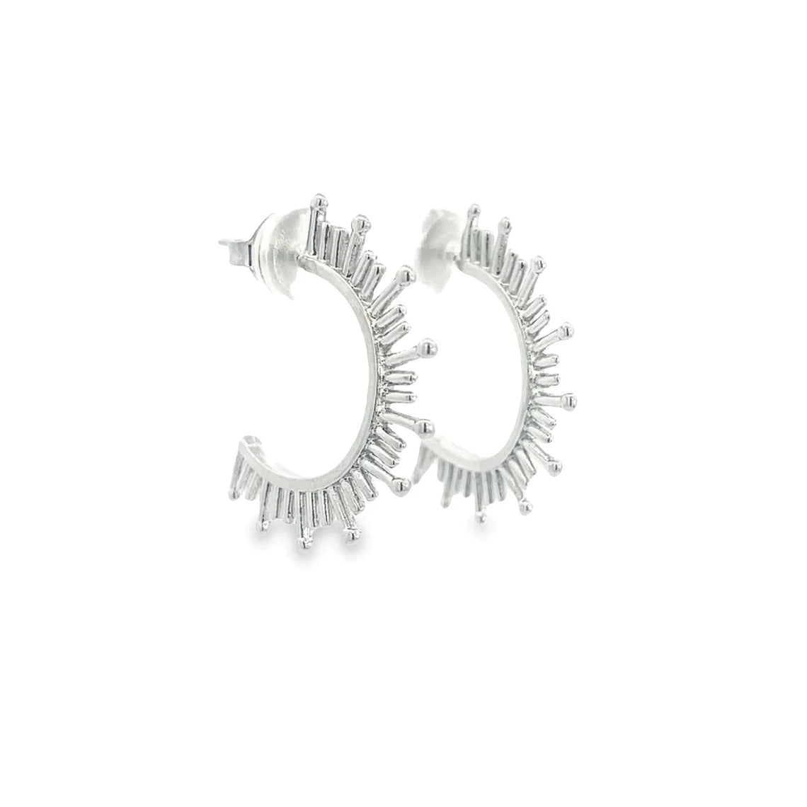 A pair of silver sunburst hoop earrings feature intricate ray-like details extending outward against a plain white background.