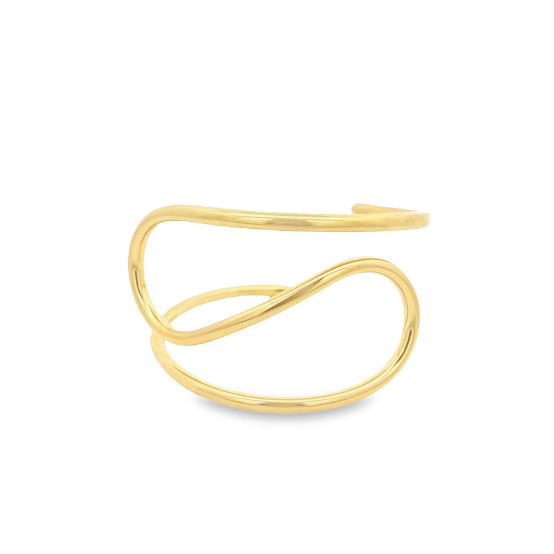 A modern gold ear cuff features a sleek, abstract multi-band design resting against a plain white background.