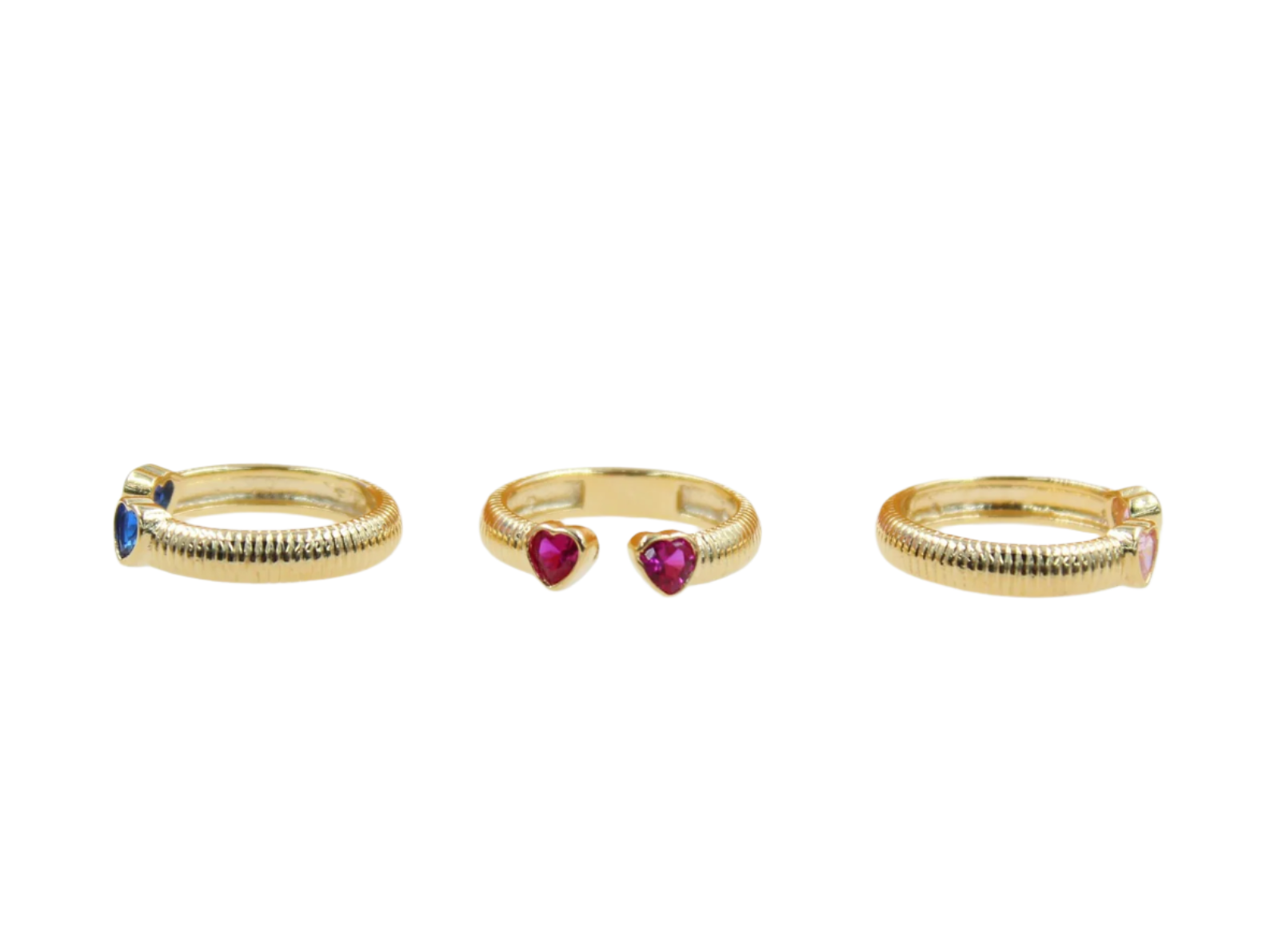 Three textured gold rings feature colorful heart-shaped gemstones in blue, red, and pink against a clean white background.
