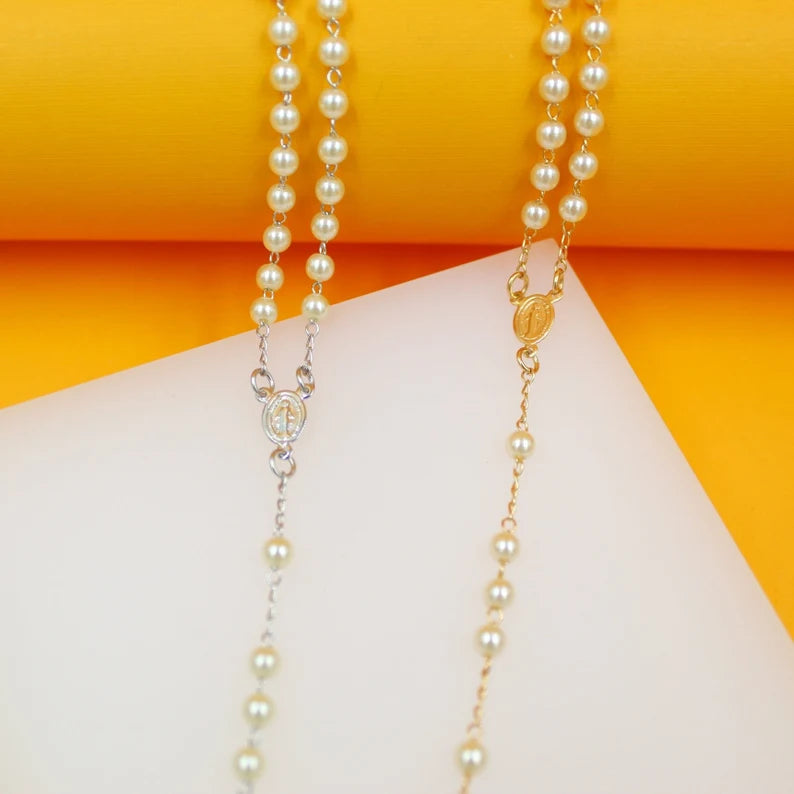 Two elegant pearl rosaries, one with silver plating and the other with gold plating, rest on a clean white and yellow display background.