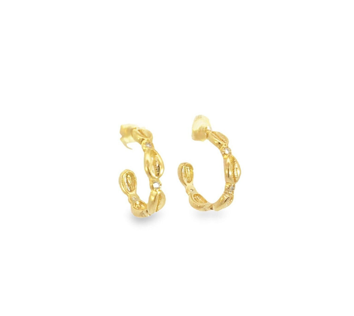 A pair of gold hoop earrings featuring a textured cowrie shell design rests against a clean white background.