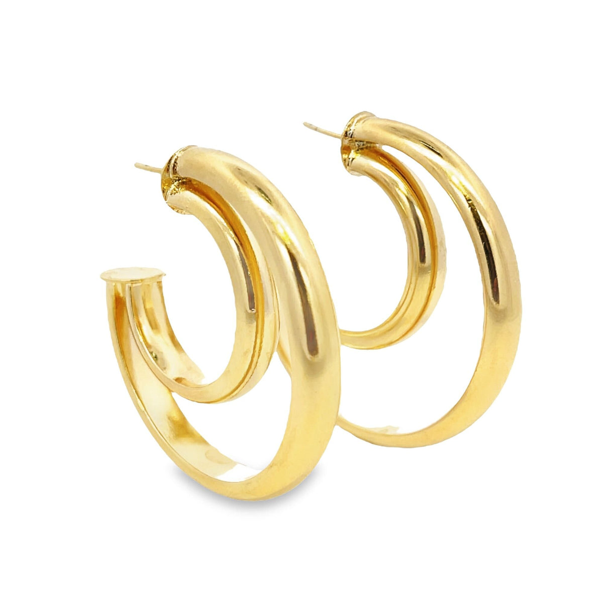 A pair of glossy gold-plated double hoop earrings gleams against a clean white background.