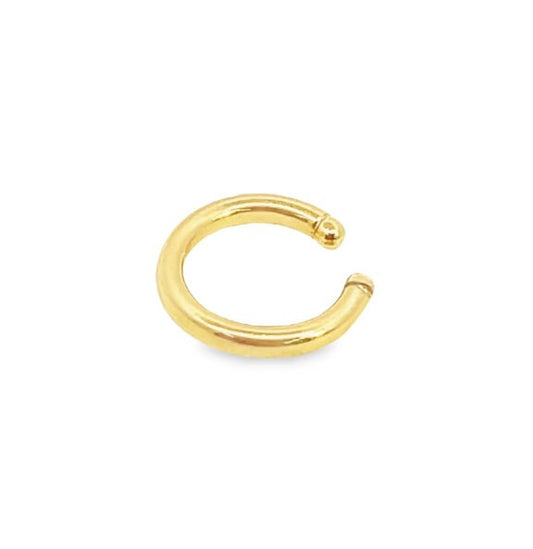 A polished gold hoop ear cuff rests against a clean white background.
