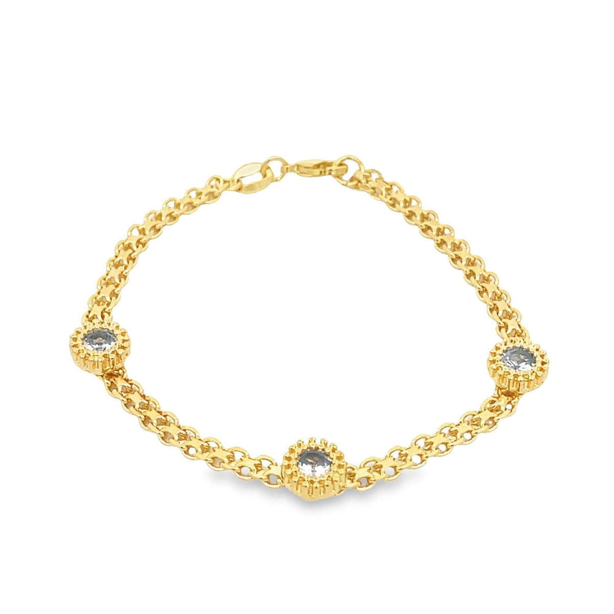 A delicate gold chain bracelet features three evenly spaced round gemstone charms against a plain white background.