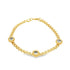 A delicate gold chain bracelet features three evenly spaced round gemstone charms against a plain white background.