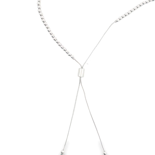 A delicate silver bolo necklace features shimmering metal beads and an adjustable sliding clasp against a clean white background.