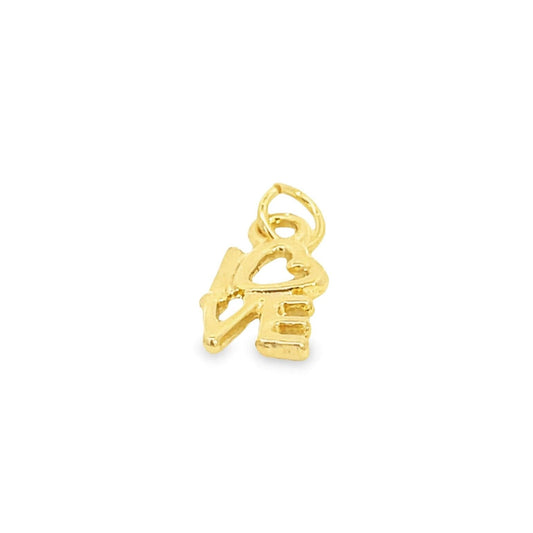 A shiny gold love charm rests against a clean white background.