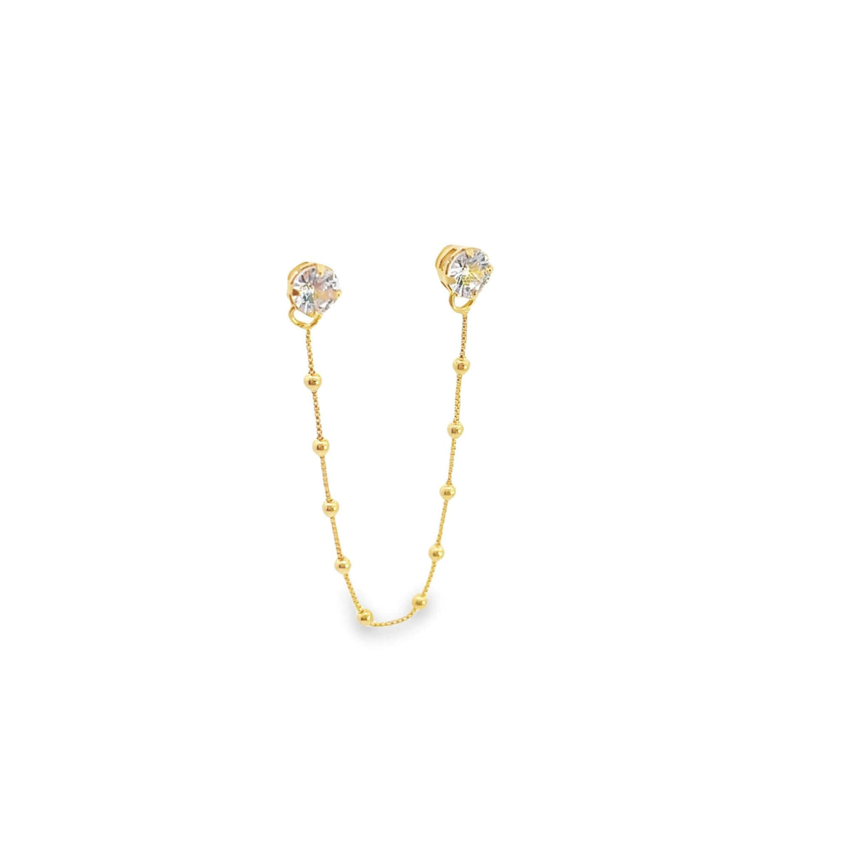 A gold chain earring features two sparkling stud stones connected by a delicate beaded drape against a white background.