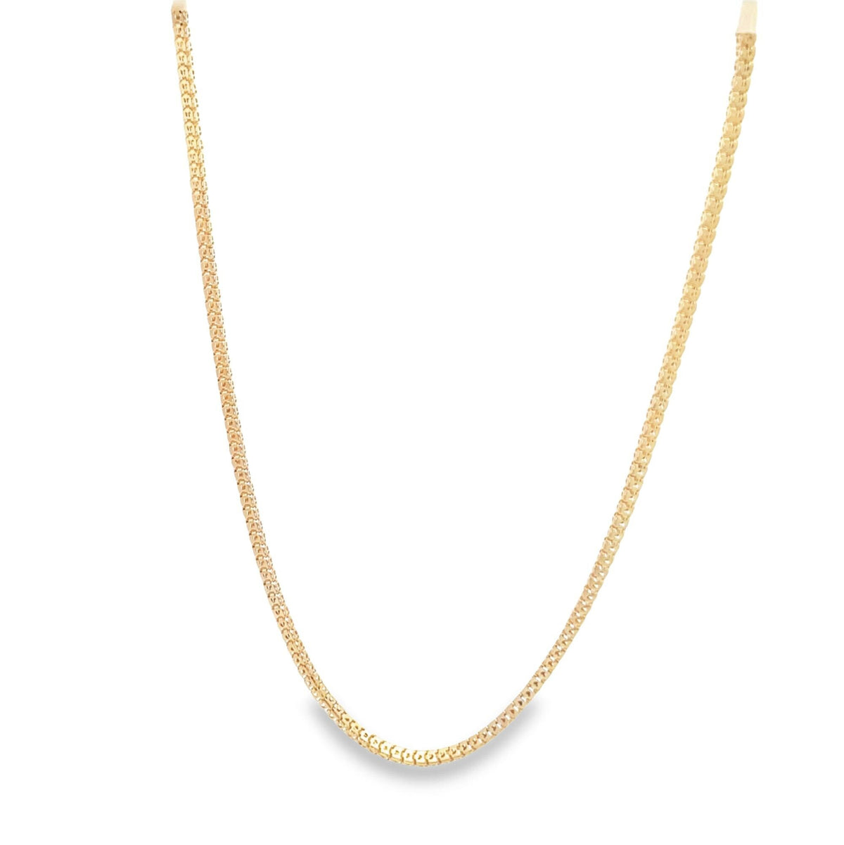 A delicate gold chain necklace hangs against a plain white background, showcasing its intricate textured links.