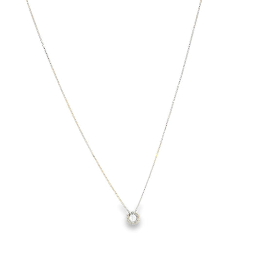 A delicate silver chain necklace features a sparkling diamond solitaire pendant centered against a plain white background.