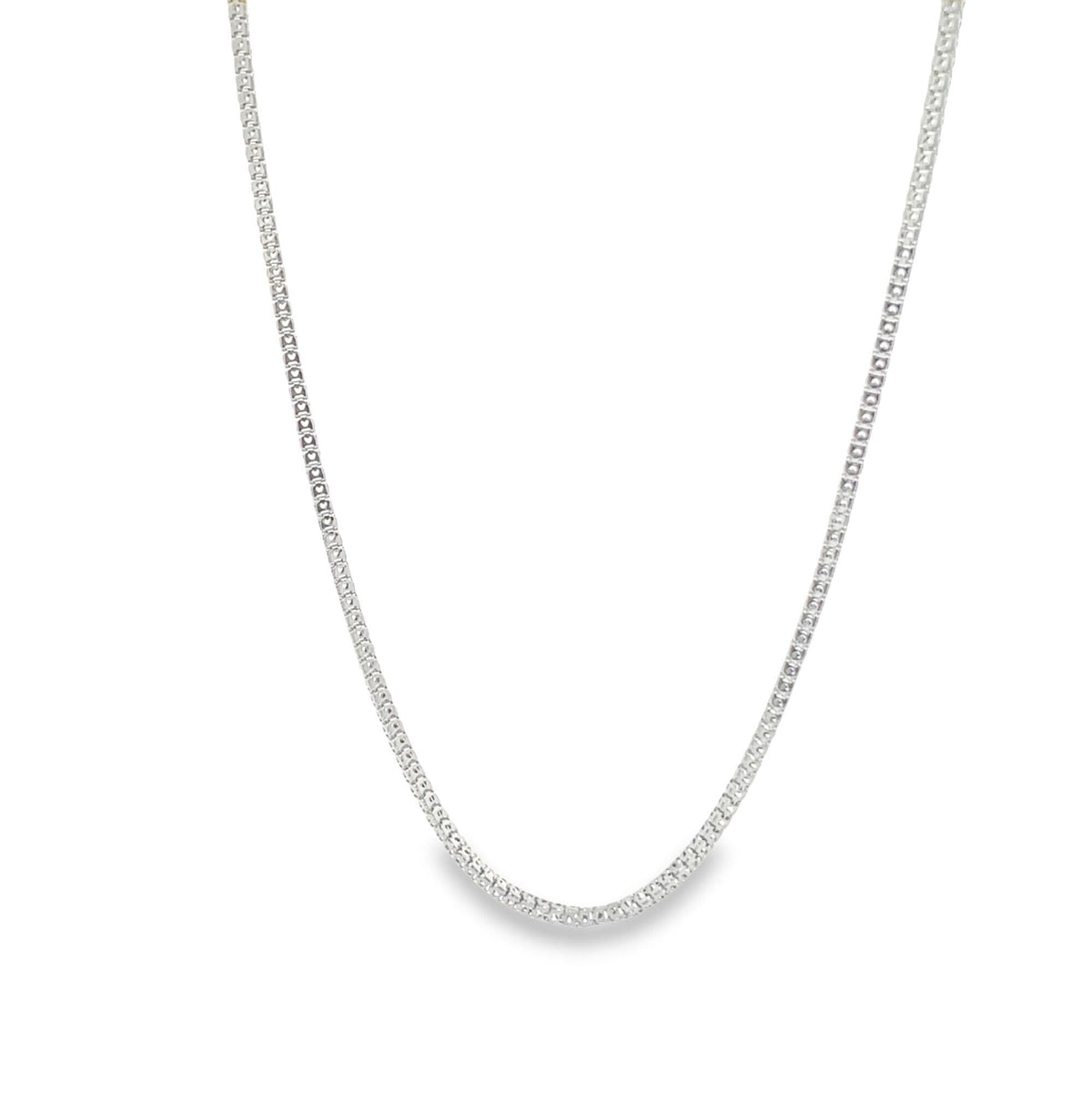 A delicate silver box chain necklace drapes gracefully against a clean white background.