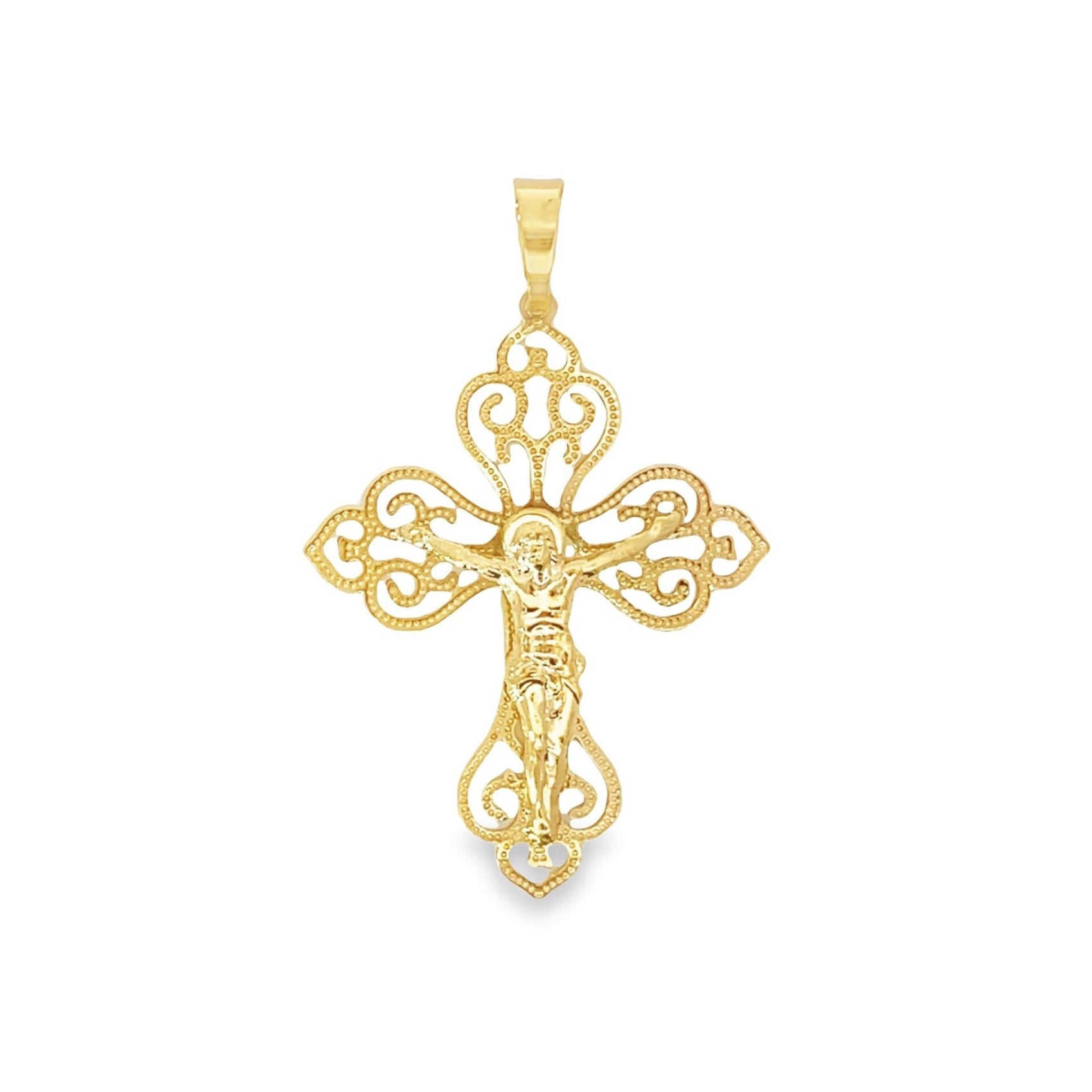 A gleaming gold crucifix pendant features intricate filigree work and scroll designs across a white background.