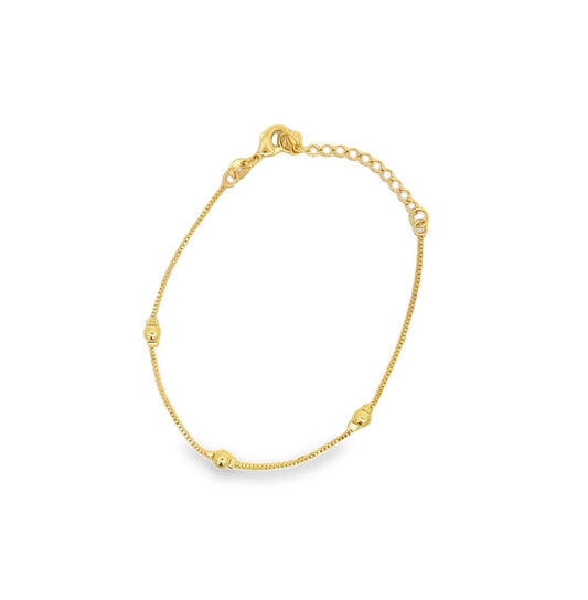 A delicate gold bracelet featuring a thin box chain accented with small round beads and an adjustable extension chain.