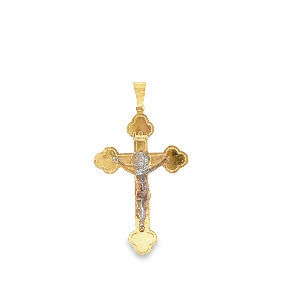 A detailed yellow gold crucifix pendant features a white gold figure of Jesus against a plain white background.