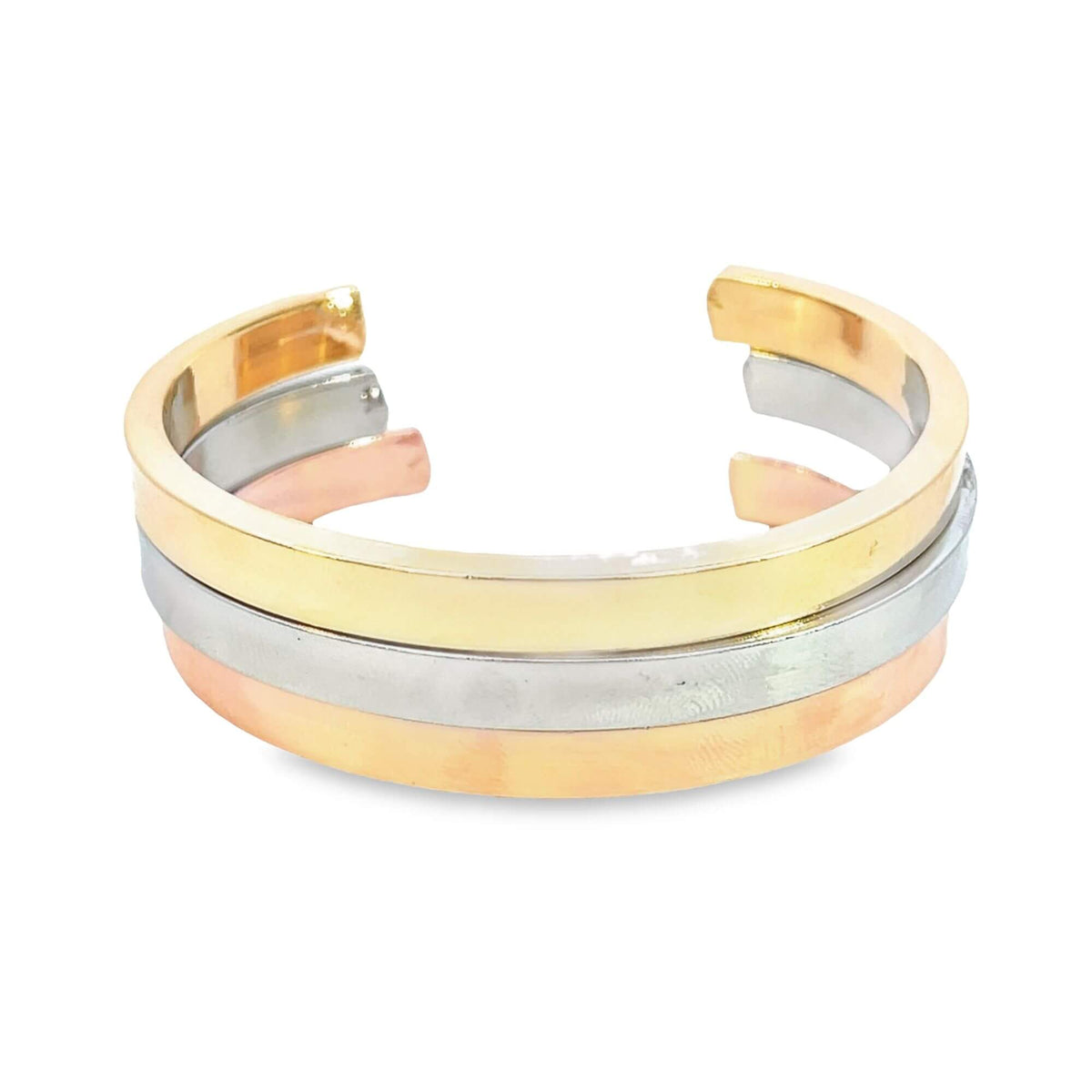 A stylish tri-color gold cuff bracelet features polished yellow, white, and rose gold bands stacked together against a clean white background.