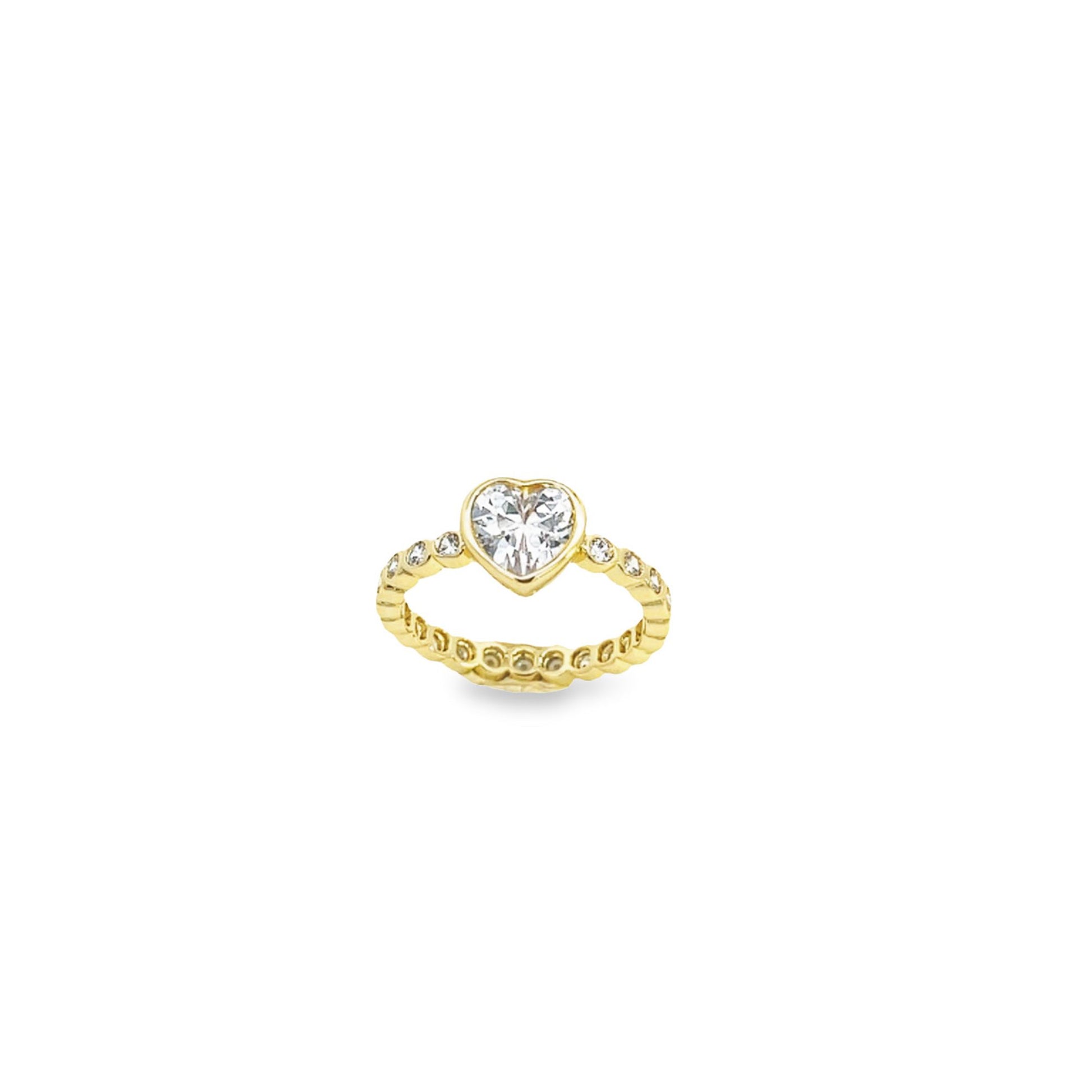 A delicate gold ring features a sparkling heart-shaped diamond centerpiece flanked by smaller pavé-set stones along the band.