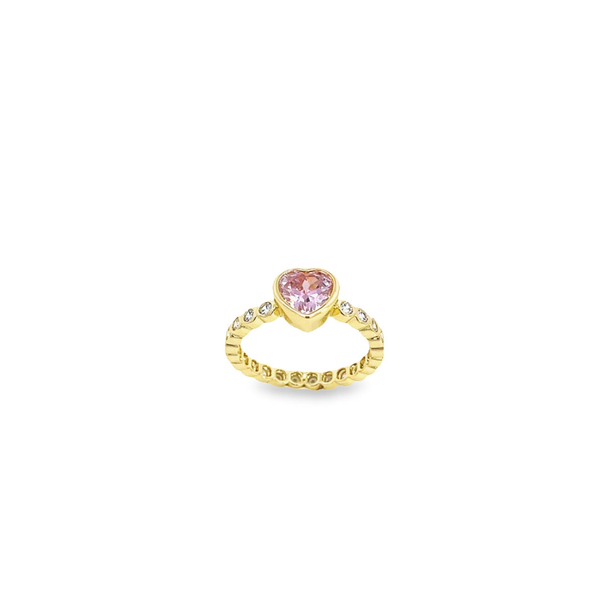 A gold ring features a sparkling pink heart-shaped center stone and diamond accents along the band.