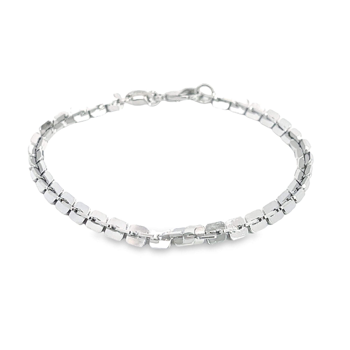 A delicate silver chain bracelet rests against a clean white background.