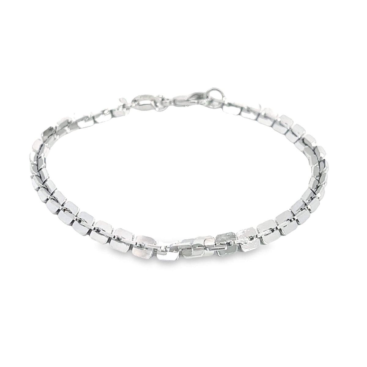 A delicate silver link bracelet rests on a clean white background, showcasing its sparkling square segments.