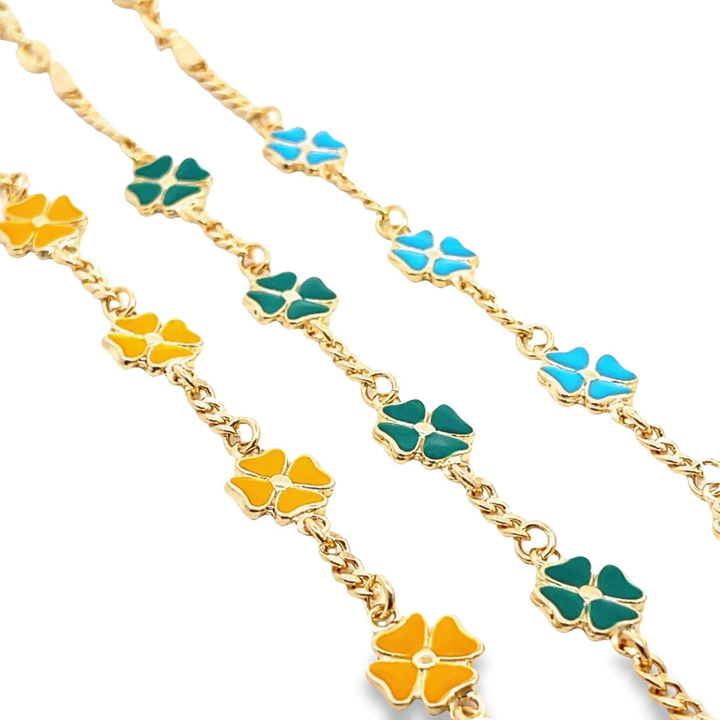 Three delicate gold chains feature alternating enamel clover charms in vibrant shades of blue, green, and yellow.