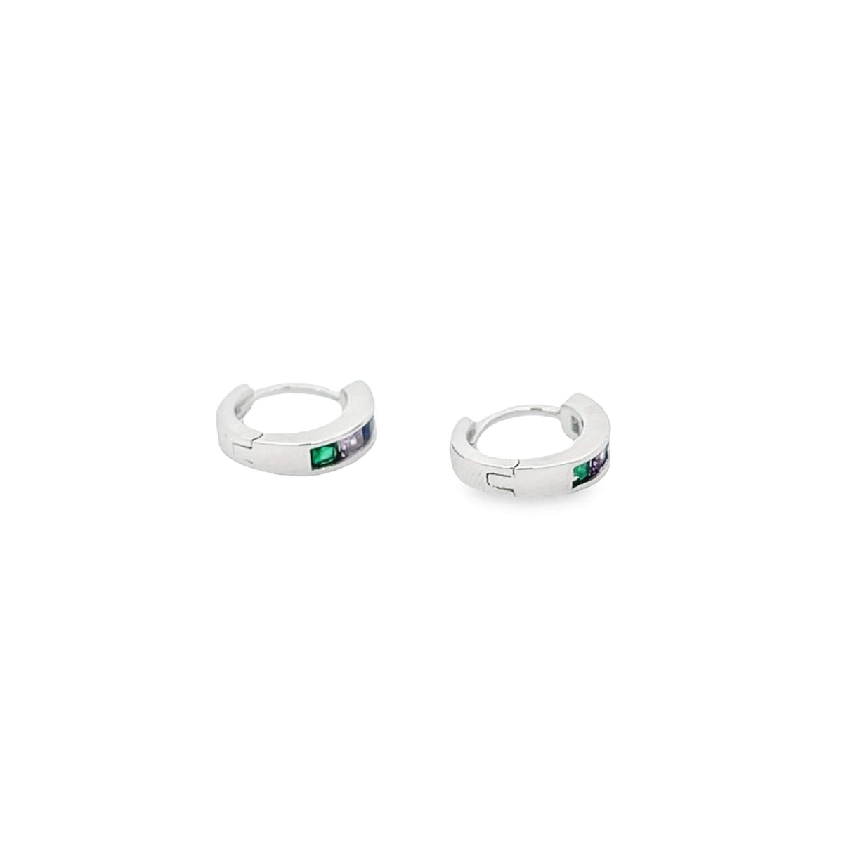 A pair of silver huggie hoop earrings features multicolored crystal baguettes set against a clean white background.