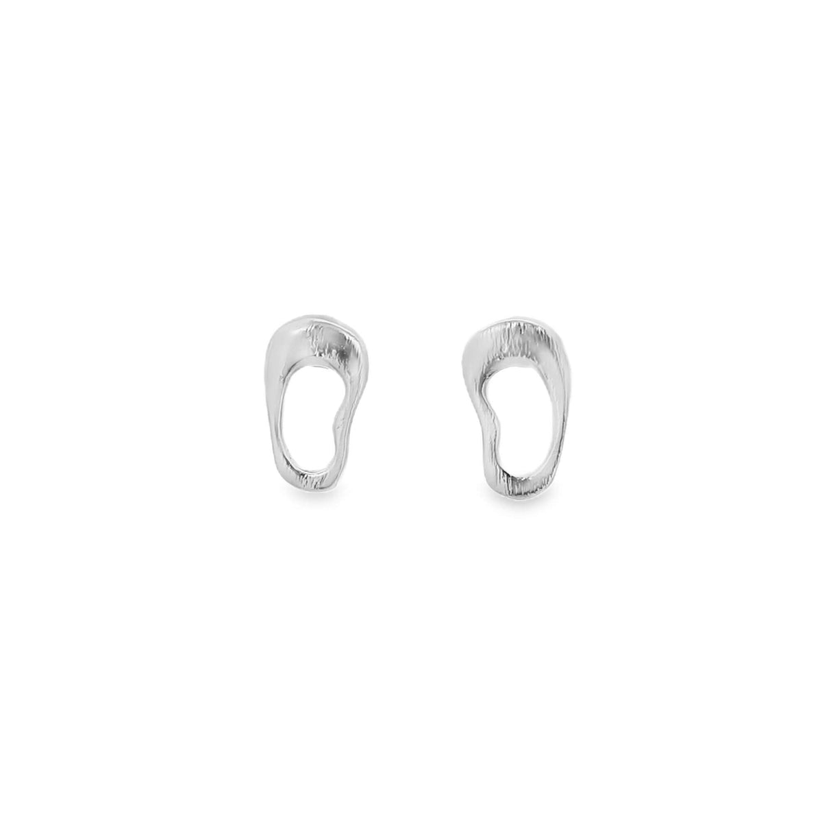 A pair of minimalist silver stud earrings with organic, open-loop shapes rests against a clean white background.