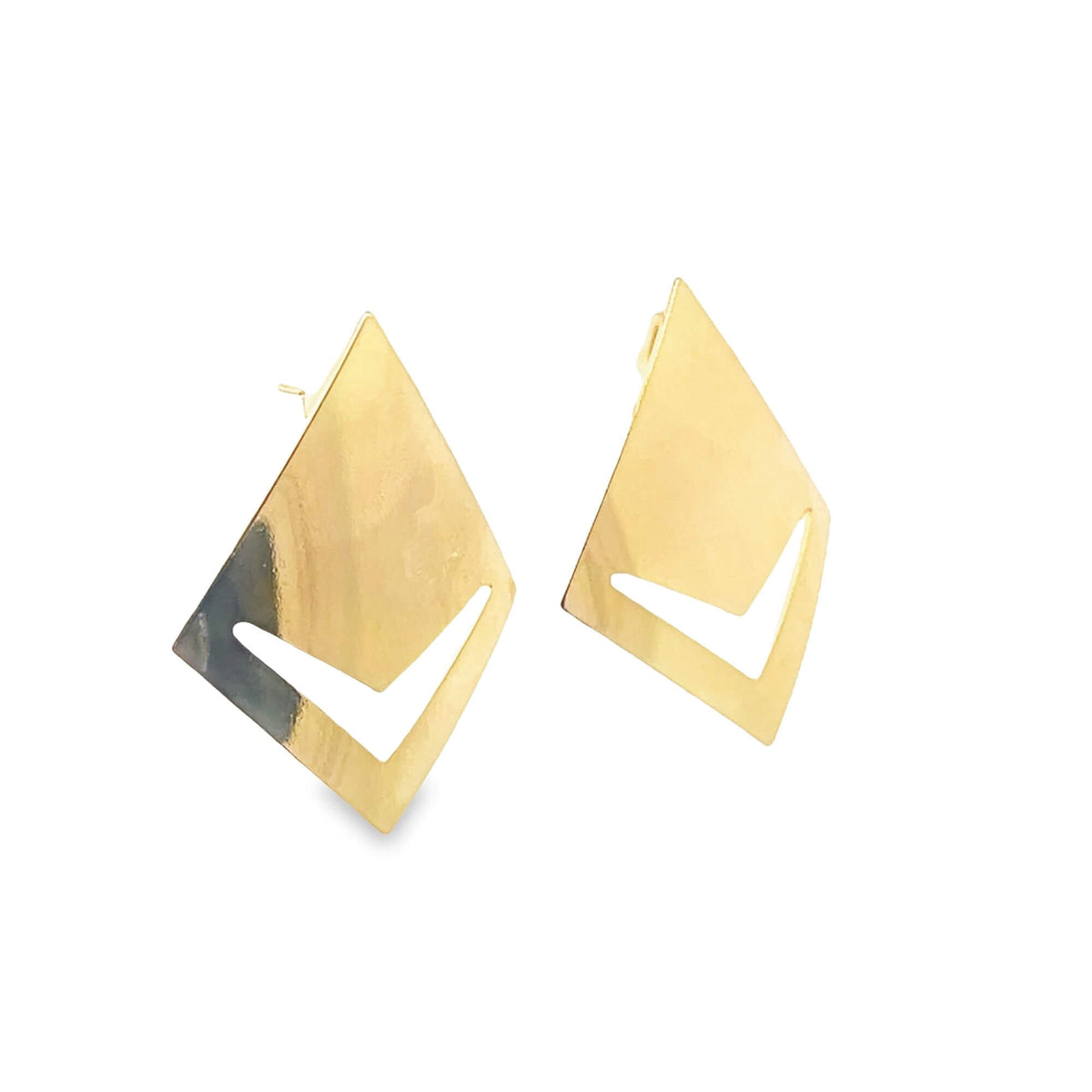 A pair of geometric gold earrings with diamond shapes and cutout chevrons gleams against a white background.