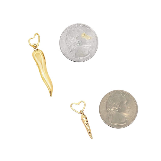 Two gold Italian horn charms with heart bails lie next to US quarters for size comparison.