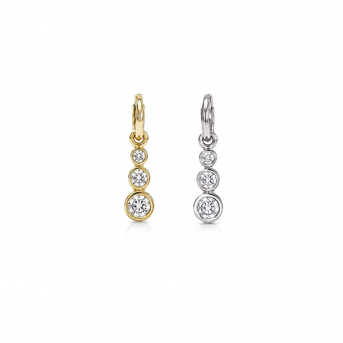 Two dangle hoop earrings featuring graduated bezel-set diamond crystals are displayed side-by-side, with one in yellow gold and the other in silver.