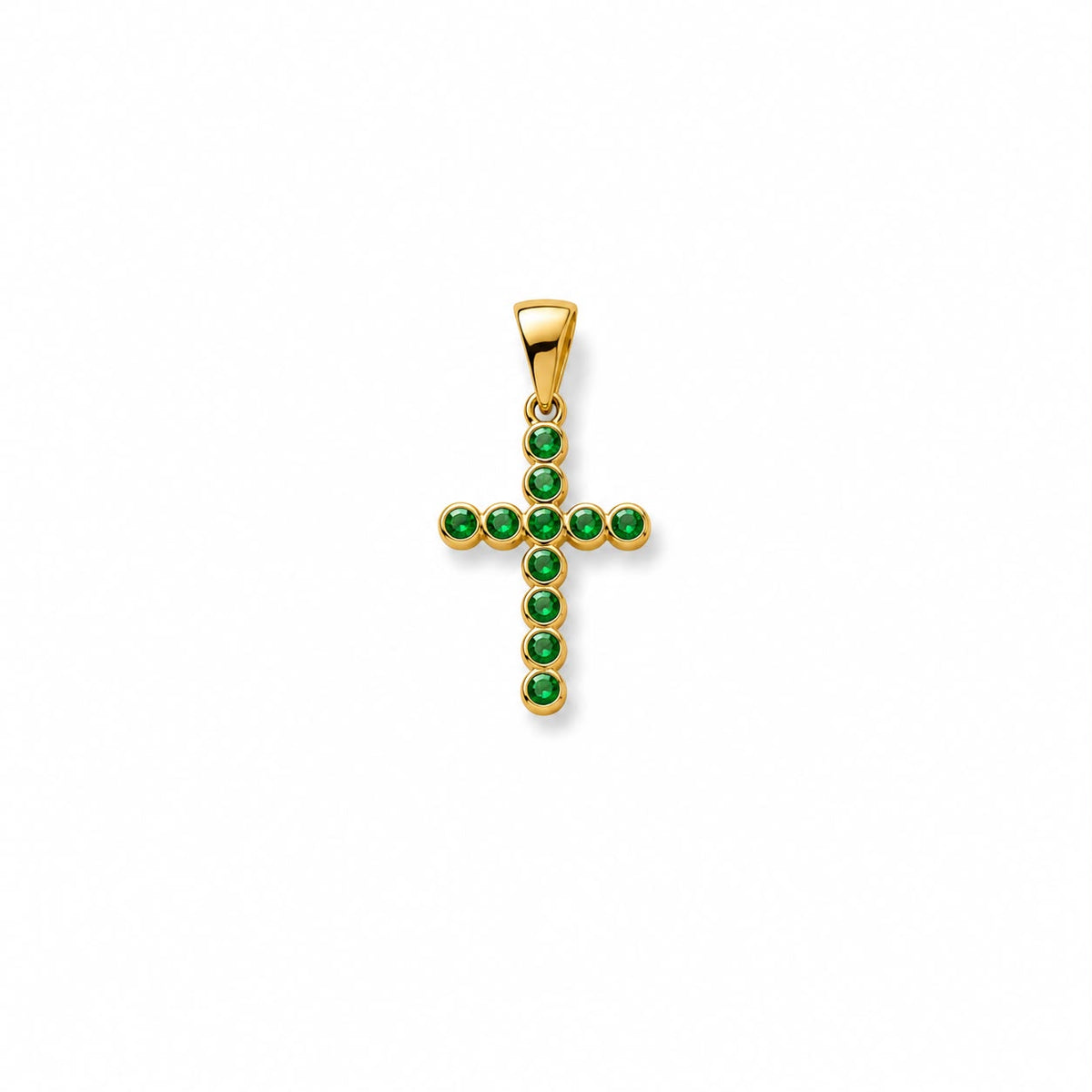 A gold cross pendant features bezel-set emerald green stones against a clean white background.