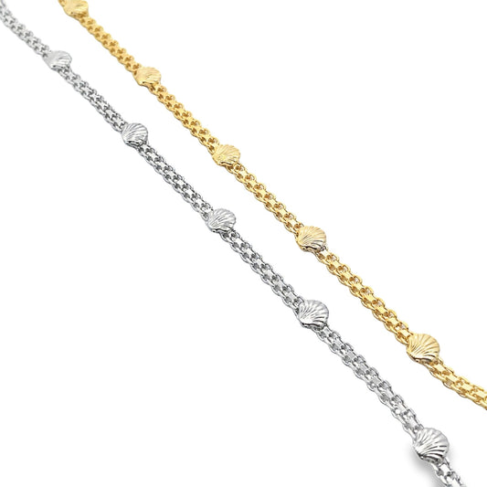 Two delicate chains, one gold and one silver, feature spaced seashell charms against a white background.