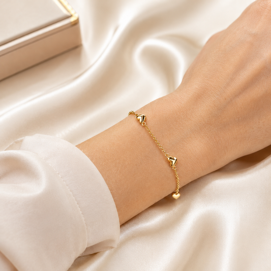 Elegant gold heart station necklace and bracelet set featuring delicate heart charms. Lightweight, minimalist, and perfect for everyday wear or gifting.
