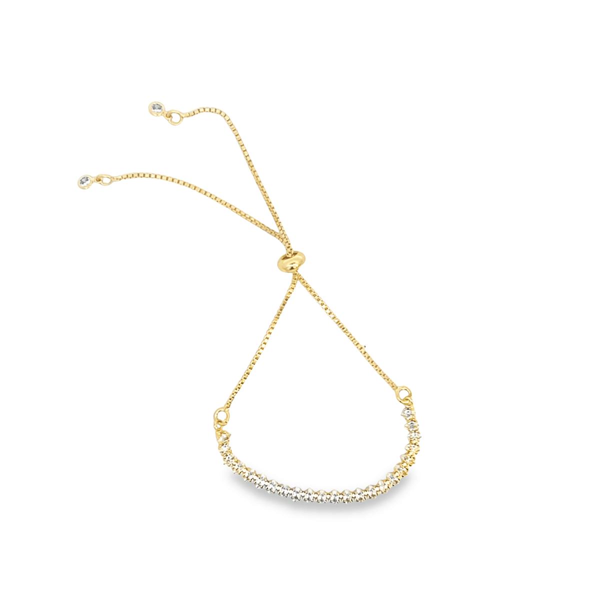 A delicate gold bolo bracelet features a curved bar sparkling with cubic zirconia stones.