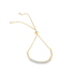 A delicate gold bolo bracelet features a curved bar sparkling with cubic zirconia stones.