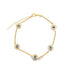 A gold chain bracelet features five delicate flower charms adorned with blue and white evil eye beads against a clean white background.