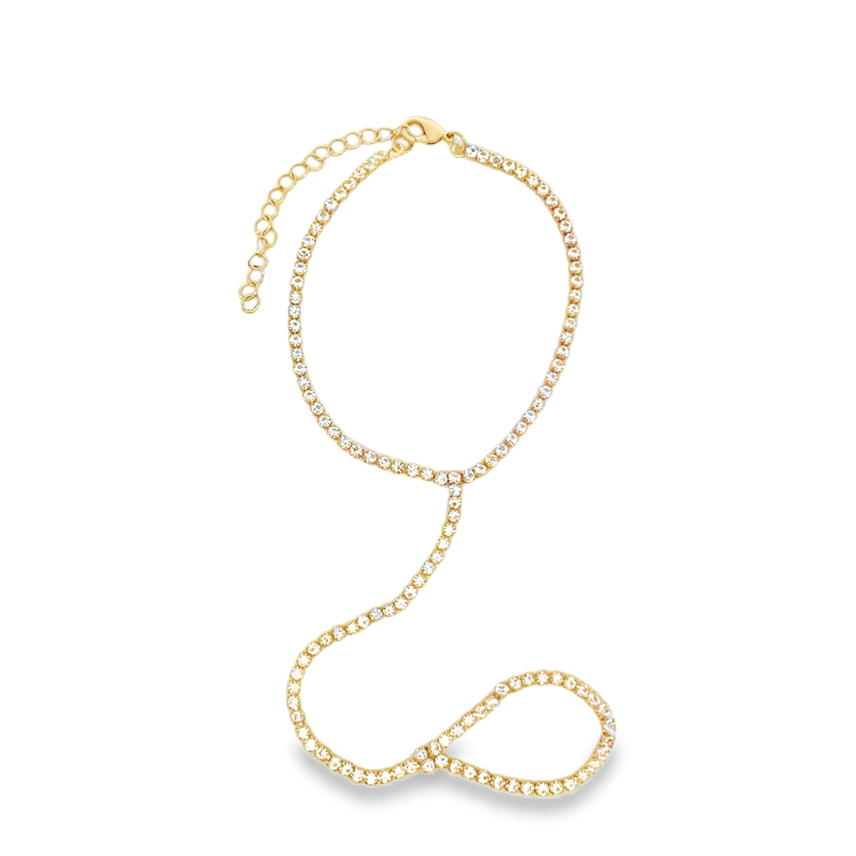 A sparkling gold rhinestone slave bracelet features a delicate chain connecting a wristband to a finger loop against a white background.
