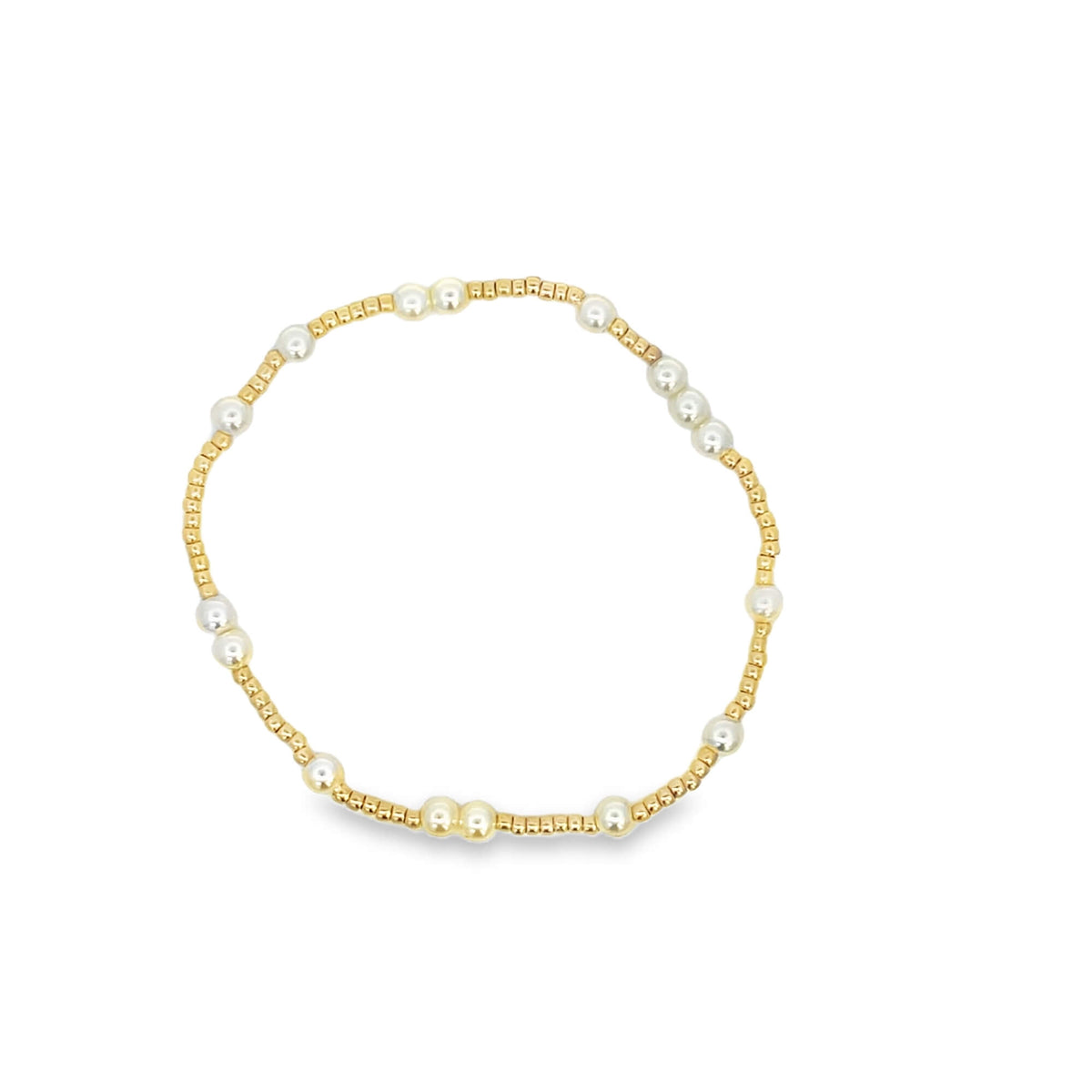Gold and pearl bracelet on a white background