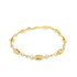 A delicate gold shell bracelet rests against a plain white background, featuring alternating cowrie shell charms and sparkling cubic zirconia stones.