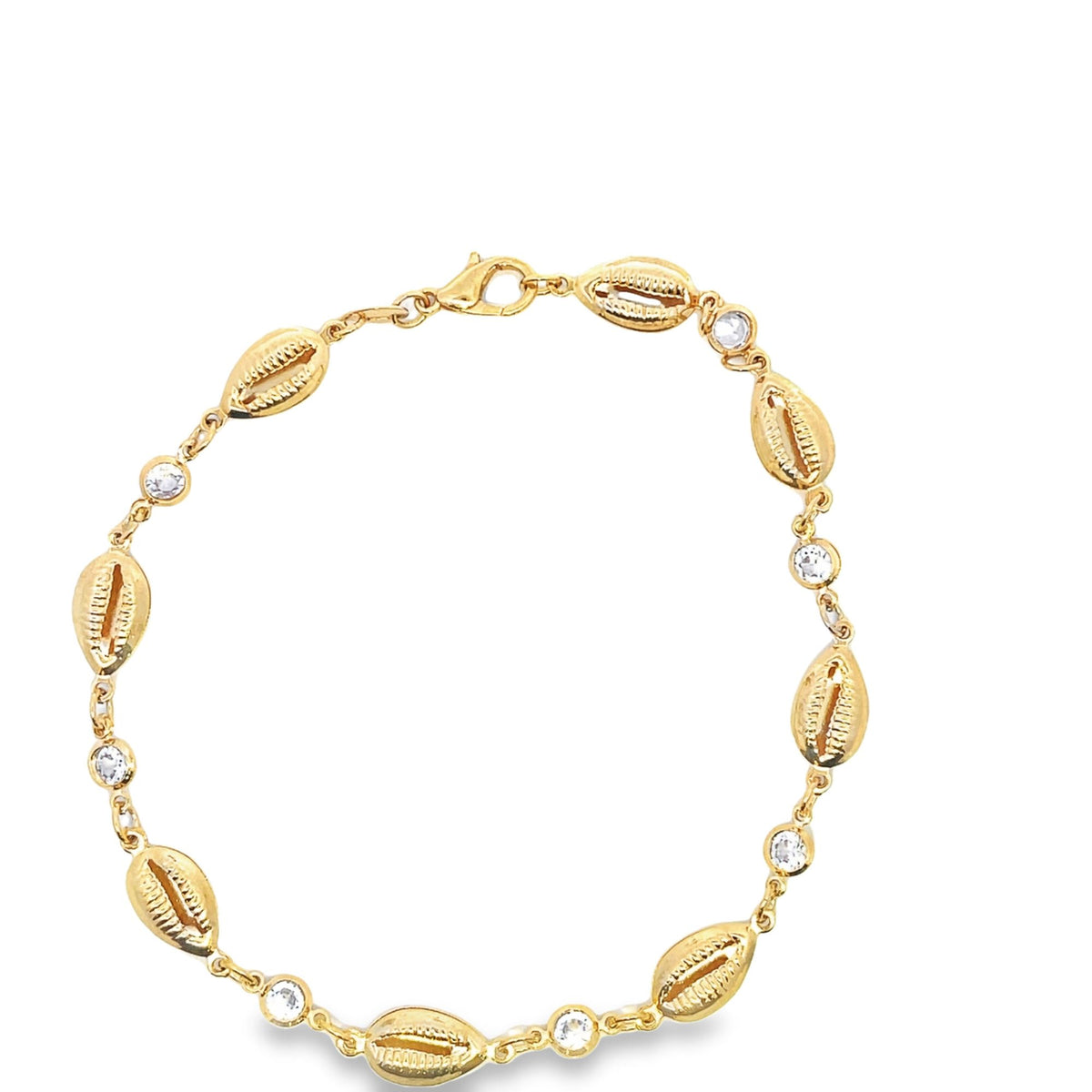A gold-plated seashell anklet features alternating cowrie shells and sparkling clear cubic zirconia stones against a clean white background.