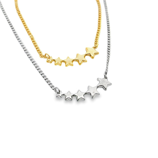Two layered necklaces display graduating gold and silver star pendants against a plain white background.
