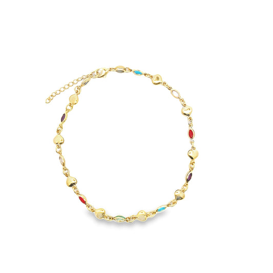 A delicate gold chain necklace sparkles with colorful gemstone inlays and small heart charms against a clean white background.