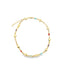 A delicate gold chain necklace sparkles against a white background, featuring alternating small heart charms and colorful gemstone inlays.