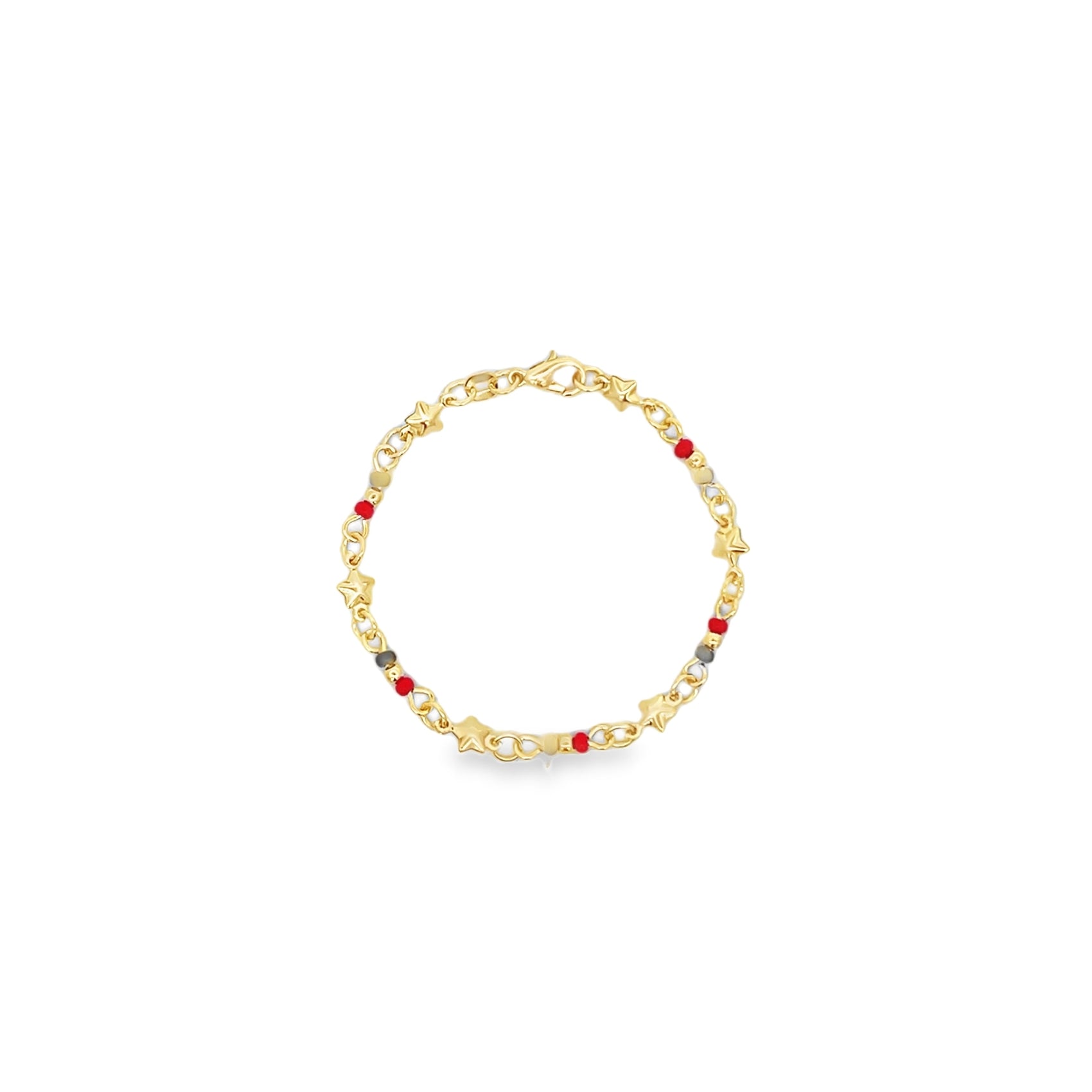 A delicate gold charm bracelet features whimsical star-shaped accents and colorful red beads against a clean white background.