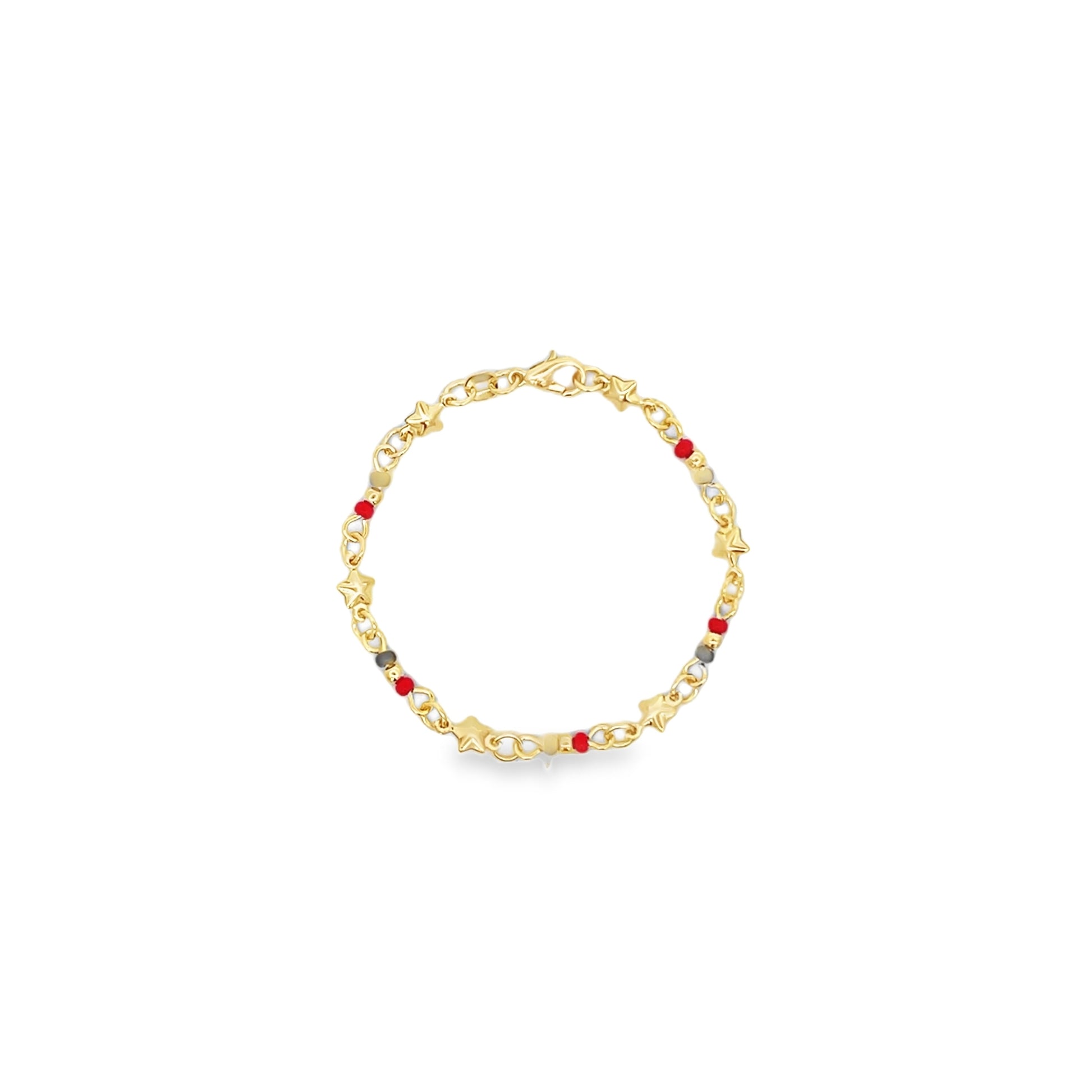 A delicate gold charm bracelet features whimsical star-shaped accents and colorful red beads against a clean white background.
