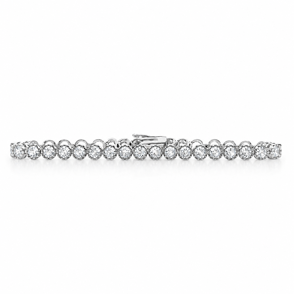 A sparkling diamond tennis bracelet lies flat against a clean white background, showcasing a continuous line of round, bezel-set stones in a white gold setting.